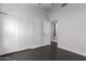 Bedroom with large closets and dark wood look tile at 15131 W Melissa Ln, Surprise, AZ 85374