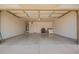 Clean garage with epoxy flooring and painted walls at 15131 W Melissa Ln, Surprise, AZ 85374