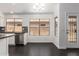 Bright kitchen area featuring dark wood flooring, stainless steel appliances, and modern finishes at 15131 W Melissa Ln, Surprise, AZ 85374