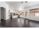 Open living space with dark wood floors flowing into a modern kitchen and inviting dining area at 15131 W Melissa Ln, Surprise, AZ 85374