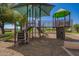 A colorful community playground with shade covering and a variety of play structures at 15131 W Melissa Ln, Surprise, AZ 85374