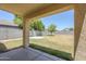A spacious backyard with a concrete patio and block fencing at 15205 N Honcho Ct, El Mirage, AZ 85335