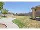 A spacious backyard with a concrete patio and block fencing at 15205 N Honcho Ct, El Mirage, AZ 85335