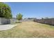Spacious backyard featuring a large grassy area and a concrete patio, perfect for outdoor activities at 15205 N Honcho Ct, El Mirage, AZ 85335