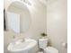 A pedestal sink and toilet are accompanied by a large, decorative mirror and soap dispenser at 15205 N Honcho Ct, El Mirage, AZ 85335
