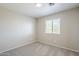 This bedroom features neutral paint, carpet, and a window at 15205 N Honcho Ct, El Mirage, AZ 85335