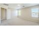 This bright bedroom has carpet flooring and natural lighting throughout the space at 15205 N Honcho Ct, El Mirage, AZ 85335