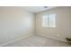 This bedroom features neutral paint, carpet, and a window at 15205 N Honcho Ct, El Mirage, AZ 85335