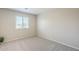 This bedroom features neutral paint, carpet, and a window at 15205 N Honcho Ct, El Mirage, AZ 85335