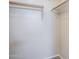 Empty closet with wooden hanging rods ready for storage, and neutral-toned carpet at 15205 N Honcho Ct, El Mirage, AZ 85335