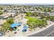Aerial view of a community park featuring a playground, basketball court, and picnic areas at 15205 N Honcho Ct, El Mirage, AZ 85335
