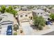 Two-story home featuring a well-maintained front yard, two-car garage, and a welcoming facade at 15205 N Honcho Ct, El Mirage, AZ 85335
