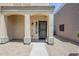 Charming covered front porch with decorative columns offering a welcoming entry to the home at 15205 N Honcho Ct, El Mirage, AZ 85335