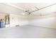 Spacious garage with painted floor and an automatic door opener at 15205 N Honcho Ct, El Mirage, AZ 85335