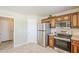 Compact kitchen featuring stainless steel appliances, wooden cabinets, and durable countertops at 15205 N Honcho Ct, El Mirage, AZ 85335