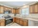 Well-appointed kitchen featuring wooden cabinets, stainless steel appliances, and plenty of counter space at 15205 N Honcho Ct, El Mirage, AZ 85335
