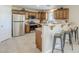 Efficient kitchen featuring stainless steel appliances, wooden cabinets, and a breakfast bar at 15205 N Honcho Ct, El Mirage, AZ 85335