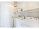 A laundry room with washer and dryer hookups and shelving at 15205 N Honcho Ct, El Mirage, AZ 85335