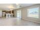 Open living space with tile floors, a breakfast bar, and sliding doors leading to the backyard at 15205 N Honcho Ct, El Mirage, AZ 85335