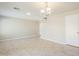 Spacious living room featuring neutral carpet, ceiling lights, and ample space for furniture at 15205 N Honcho Ct, El Mirage, AZ 85335