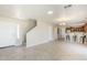 Bright living room featuring tile floors and an open floorplan with direct access to the kitchen at 15205 N Honcho Ct, El Mirage, AZ 85335