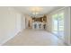 Open concept living room with tile floors, kitchen with bar and sliding glass door to the back at 15205 N Honcho Ct, El Mirage, AZ 85335