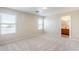 Large carpeted main bedroom with natural light and an open en-suite bathroom at 15205 N Honcho Ct, El Mirage, AZ 85335