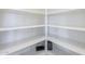 A brightly lit, walk-in pantry with wooden shelving for dry goods and storage at 15205 N Honcho Ct, El Mirage, AZ 85335