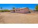 Rear exterior of the home featuring a light pink exterior and a spacious low maintenance yard at 1531 W Campo Bello Dr, Phoenix, AZ 85023