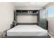 Bedroom with stylish hardwood floors and a built-in murphy bed, extended into a bed at 1531 W Campo Bello Dr, Phoenix, AZ 85023