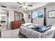 Comfortable bedroom featuring a dresser with mirror, ceiling fan, and plush carpeting at 1531 W Campo Bello Dr, Phoenix, AZ 85023
