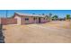 Exterior side view of the home featuring a light pink exterior, a well-kept fence, and low maintenance yard at 1531 W Campo Bello Dr, Phoenix, AZ 85023