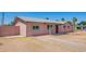 Home's exterior side view featuring a light pink exterior, a well-kept fence, and low maintenance yard at 1531 W Campo Bello Dr, Phoenix, AZ 85023