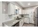 Bright kitchen with white cabinets, granite countertops, and stainless steel appliances at 1531 W Campo Bello Dr, Phoenix, AZ 85023