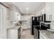 Well-lit kitchen with white cabinets, granite countertops, and stainless steel appliances at 1531 W Campo Bello Dr, Phoenix, AZ 85023