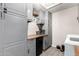 Stylish laundry area equipped with gray cabinets, wood counters, a mini-fridge, and modern washer/dryer at 1531 W Campo Bello Dr, Phoenix, AZ 85023