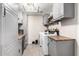 Modern laundry room featuring gray cabinetry, wood countertops, and stainless-steel appliances at 1531 W Campo Bello Dr, Phoenix, AZ 85023