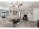 Bright living room with a ceiling fan, wood laminate floors, white couch, and stylish decor at 1531 W Campo Bello Dr, Phoenix, AZ 85023