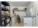 Spacious storage room with shelves, a workbench, and an open freezer for efficient organization at 1531 W Campo Bello Dr, Phoenix, AZ 85023