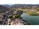 Elevated view of lakeside homes and golf course in a lush community with mountains at 16239 S 18Th Pl, Phoenix, AZ 85048