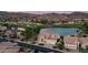 Stunning aerial view of the property in a golf course community with a lake, fountain, and mountain backdrop at 16239 S 18Th Pl, Phoenix, AZ 85048