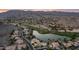 An aerial view featuring a lakeside golf course community nestled against mountains and the surrounding neighborhood at 16239 S 18Th Pl, Phoenix, AZ 85048