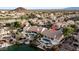 Aerial view of a home with pool and lake access, surrounded by lush landscaping and mature trees at 16239 S 18Th Pl, Phoenix, AZ 85048
