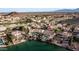 Aerial view of home with pool and lake access, nestled in a green community with palm trees at 16239 S 18Th Pl, Phoenix, AZ 85048