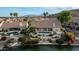 Aerial view of a luxury home with a pool, patio, lush landscaping, and lake access at 16239 S 18Th Pl, Phoenix, AZ 85048