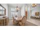 Formal dining room showcasing an elegant chandelier, a classic dining set, and ample natural light at 16239 S 18Th Pl, Phoenix, AZ 85048