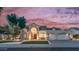 Inviting home with an arched entryway, manicured lawn, and a fountain at 16239 S 18Th Pl, Phoenix, AZ 85048