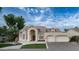 Charming home with manicured lawn, fountain feature, and a spacious three-car garage, offering curb appeal at 16239 S 18Th Pl, Phoenix, AZ 85048