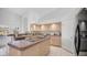 Bright kitchen features an island, stainless steel appliances, and a picturesque view of the lake at 16239 S 18Th Pl, Phoenix, AZ 85048