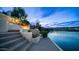 Dusk view of a lake from a backyard featuring a stairway, patio area and landscaped yard at 16239 S 18Th Pl, Phoenix, AZ 85048